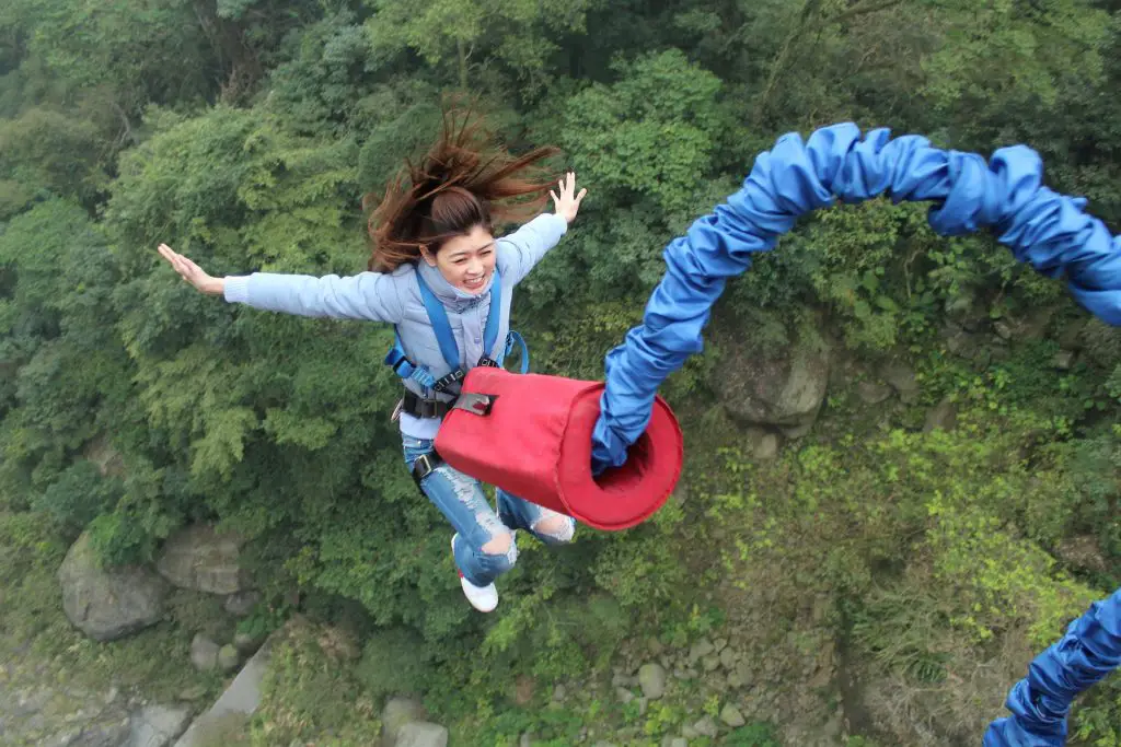 Woman bungee jumping for bachelorette party with adrenaline