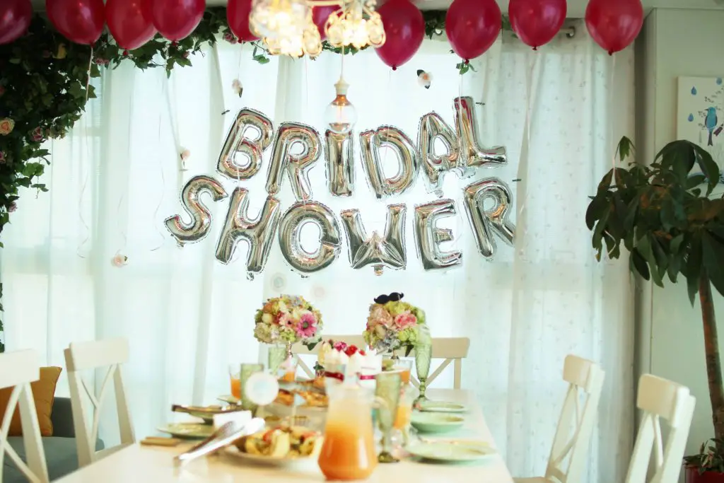 Garland "Bridal Shower" hangs over pretty decorated table surrounded by balloons